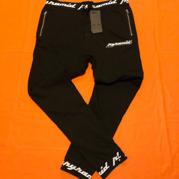 Black Pyramid Sweatpants Black Tapered Leg Sweatpants For Streetwear, Black Athleisure Bottoms With Tapered Leg, Fitted Black Joggers With Side Pockets, Fitted Black Urban Sweatpants, Black Fitted Urban Sweatpants, Black Tapered Leg Athleisure Bottoms, Black Athleisure Trousers, Urban Black Tapered Leg Joggers, Black Stretch Urban Joggers