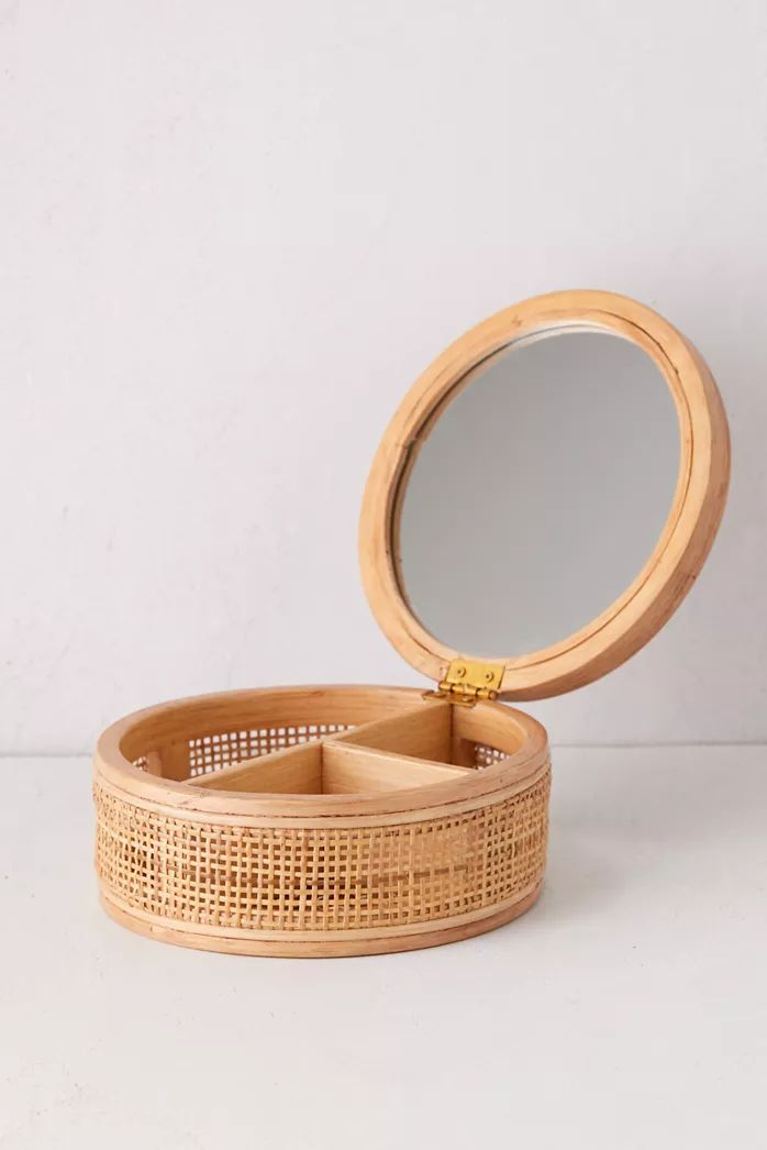 a round wooden box with a mirror on the inside and lid in front of it