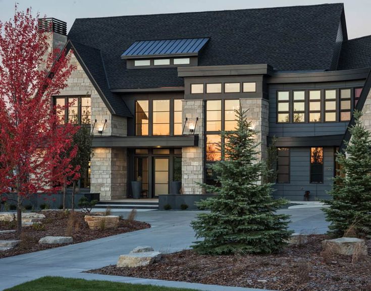 a large house with lots of windows and trees