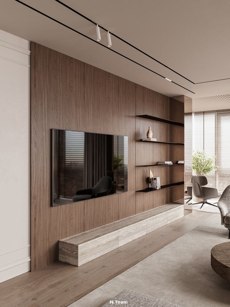 a living room with a large tv mounted on the wall next to a table and chairs