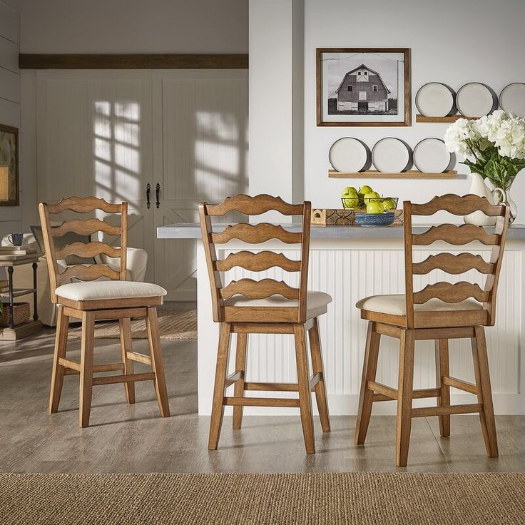 the kitchen table is set with four chairs