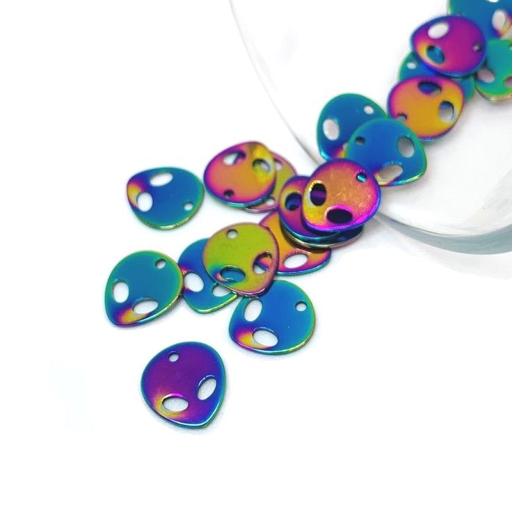 multicolored beads are laying on a white surface