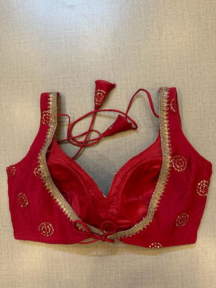 Alluring red embroidered sleeveless saree blouse. Buy designer blouse in USA from Pure Elegance. Disclaimer: The actual product may vary slightly from the image. These are custom orders, hence expect slight variation in color, placement of the motif or buta. ESTIMATED DELIVERYBecause this is a custom order, it would take about 4 weeks from the date of purchase. RETURN POLICY: This product is a custom order and cannot be returned or exchanged. Sleeveless Chanderi Blouse Piece With Mirror Work, Traditional Chanderi Lehenga, Traditional Sleeveless Chanderi Lehenga, Sleeveless Chanderi Traditional Wear For Party, Designer Wear Sleeveless Art Silk Saree, Festive Sleeveless Traditional Wear With Cutdana, Sleeveless Art Silk Traditional Wear With Cutdana, Sleeveless Anarkali With Mirror Work, Sleeveless Chanderi Traditional Wear For Navratri