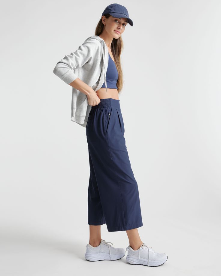 These look like classic work pants, but move like your favorite activewear. Our cropped Performance Tech Wide Leg Commuter Pants have just the right amount of stretch for days when you’re on the go, plus the sun protection and quick-dry properties of top-notch performance wear. And they look great with sneakers.  | Quince | Women's Performance Tech Wide Leg Pants in Navy, Size XS, Recycled Polyester Athleisure Pants With Comfort Waistband For Work, Solid Color Activewear With Comfort Waistband For Work, Compressive Athleisure Bottoms For Workwear, Compressive Wide Leg Athleisure Pants, High-waisted Athleisure Pants For Gym, Functional Relaxed Fit Activewear For Work, Casual Yoga Pants With Comfort Waistband For Work, Athleisure High-waisted Gym Pants, Summer Athleisure Yoga Pants