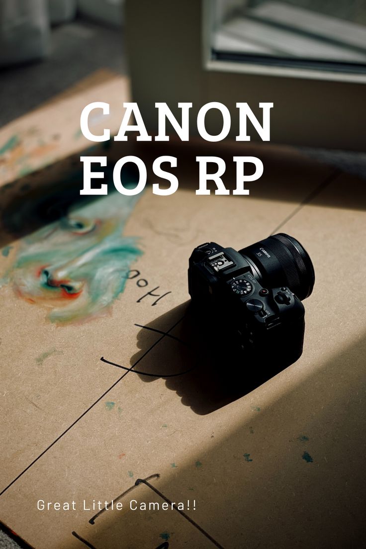 a camera sitting on top of a cardboard box with the words canon eos rp