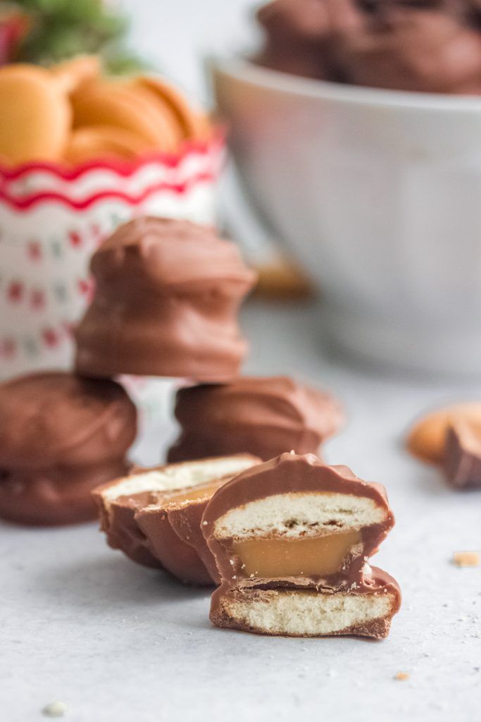 some chocolates are stacked on top of each other in front of a white bowl