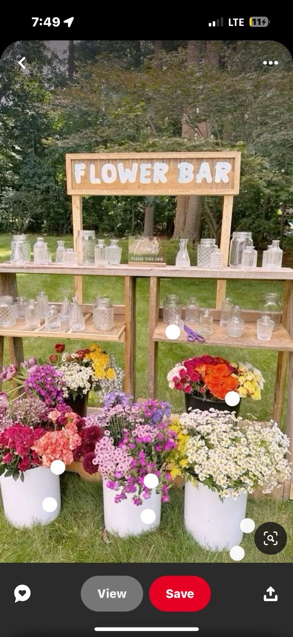 flower bar on the grass with flowers in buckets