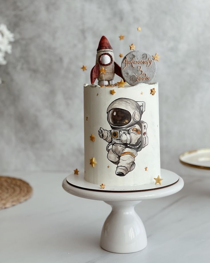 a small cake with an astronaut on top