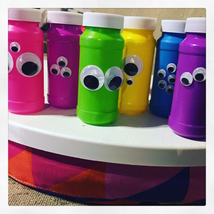 five water bottles with eyes and googly eyes on them