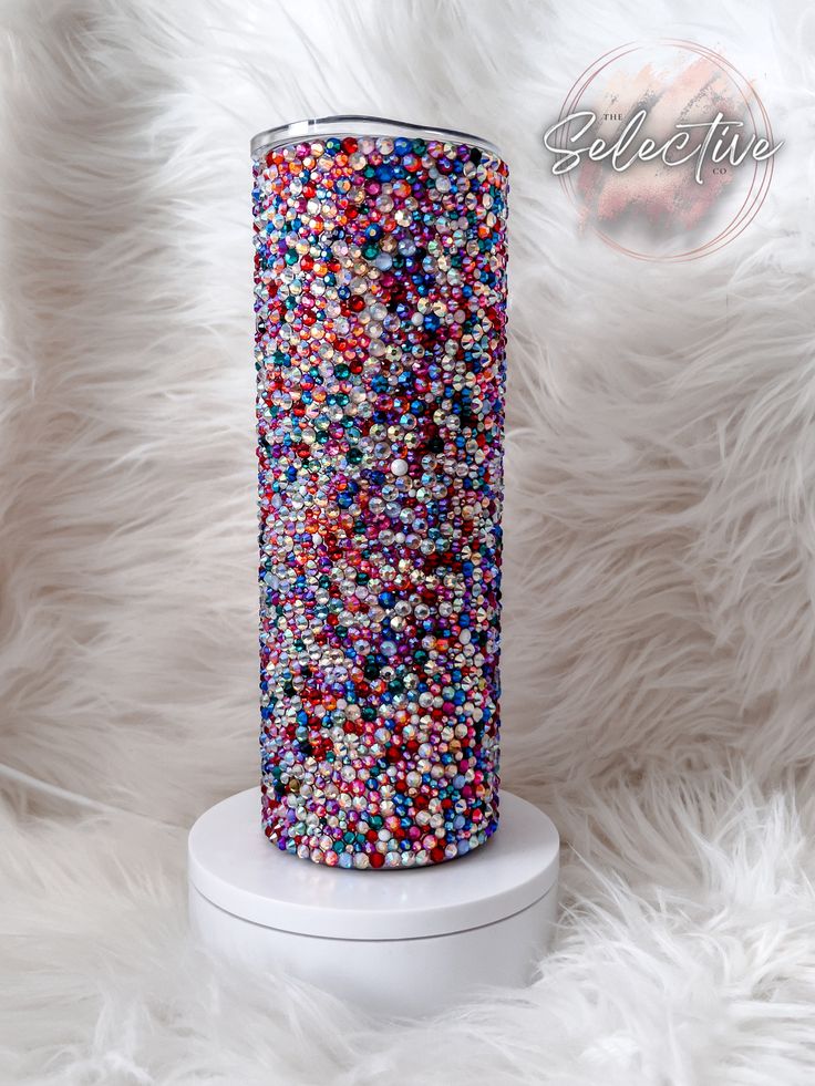 the vase is filled with multicolored sprinkles on white furnishing