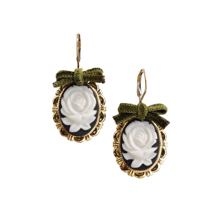 These rose cameo earrings are not only a fashion piece, but also an art piece. The cameos are carefully handcrafted and hand-painted from fine white porcelain. They experienced more than 15 hours kiln firing, with temperatures reaching over 1200°C. The earrings feature a dark romantic look with the black and gold tone finish and the highlighted olive green velvet ribbon bows. Earrings come with 14K gold-filled leverback ear hooks.Handmade porcelain cameos14K Gold-filled leverback ear hooksGold p Green Velvet Ribbon, Bows Earrings, Olive Green Velvet, Victoria Fashion, Cameo Earrings, Dark Romantic, Handmade Porcelain, Porcelain Jewelry, Kiln Firing