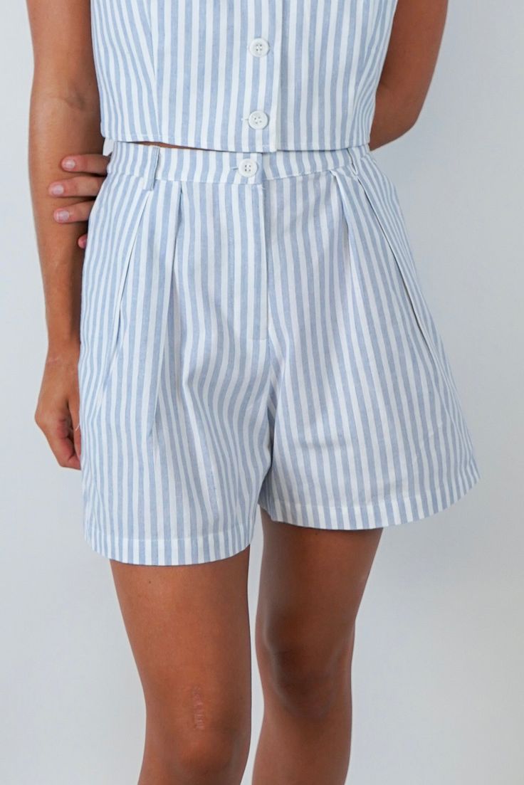 Introducing the Alice Stripe Crop Top, a luxurious addition to your wardrobe. Crafted with blue and white stripes, these shorts feature front pleats, button and zipper closure and elastic back for a comfortable fit. Pair it with the coordinating Alice Crop Top for a sophisticated and exclusive ensemble. Size + Fit Riley is 5’7” and wearing a size Small Content + Care 75% Cotton 25% Polyester Hand Wash Cold Color Separate Striped Cotton Shorts With Drawstring, Blue Vertical Stripes Short Bottoms, Trendy Striped Shorts With Built-in Shorts, Striped Pajama Shorts With Built-in Shorts, Sneaker Heels Wedges, Striped Cotton Bottoms With Built-in Shorts, Matching Sets Outfit, Striped Crop Top, Sneaker Heels