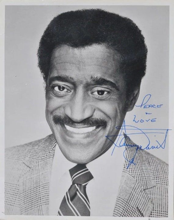 an autographed portrait of a man wearing a suit and tie