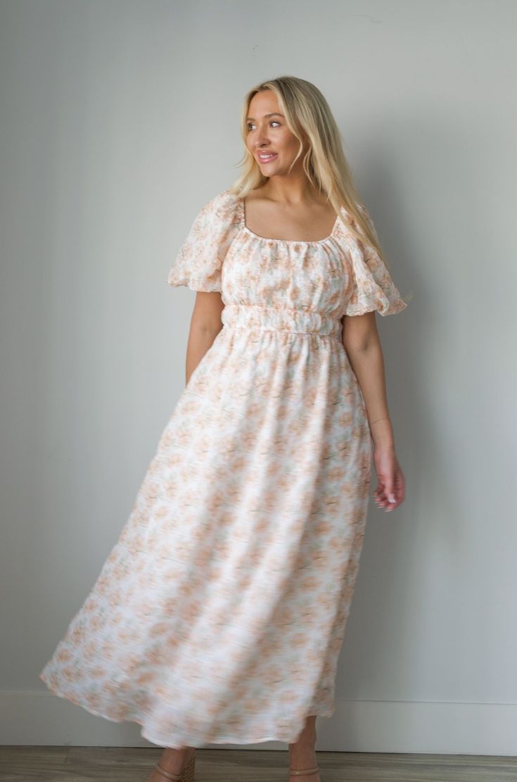 Expertly crafted for style and comfort, our Blossom Floral Print Midi Dress in Peachy is perfect for any occasion. Featuring charming puff sleeves, a flattering elastic waist, and convenient pockets, this dress effortlessly combines classic elegance with modern functionality. The square neck adds a touch of sophistication, making it a must-have for any wardrobe. square neckline puff sleeves elastic waist lined 100% polyester true to size model is wearing a medium Feminine Puff Sleeve Midi Dress For Beach, Feminine Beach Midi Dress With Puff Sleeves, Beige Fitted Waist Dress For Spring, Fitted Waist Midi Dress For Brunch, Spring Garden Party Maxi Puff Sleeve Dress, Spring Garden Party Maxi Dress With Puff Sleeves, Spring Garden Party Maxi Length Puff Sleeve Dress, Feminine Puff Sleeve Maxi Dress For Vacation, Spring Dresses With Gathered Waist And Puff Sleeves