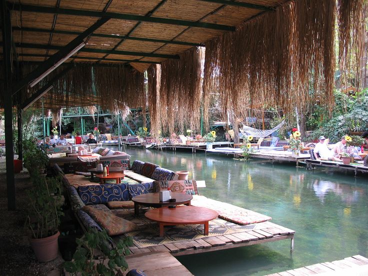 an outdoor seating area next to the water