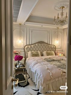 a bedroom with a bed and chandelier in it