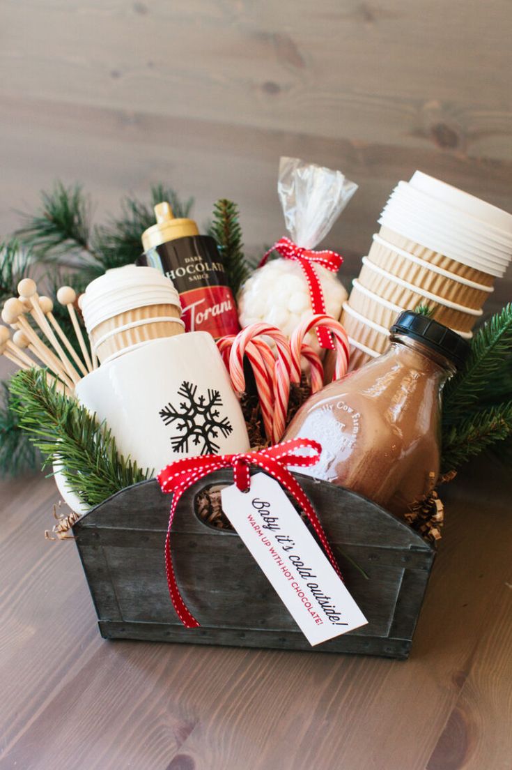 a basket filled with hot chocolates, marshmallows and candy canes