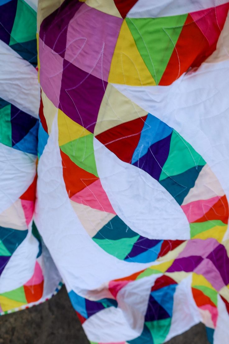 a person holding a large colorful piece of cloth