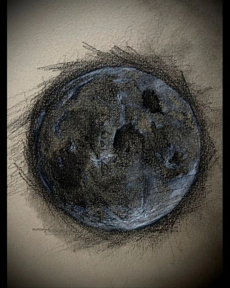 a drawing of the moon in black and white with some color pencils on it