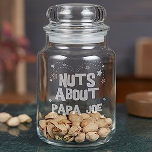 a glass jar filled with nuts sitting on top of a counter