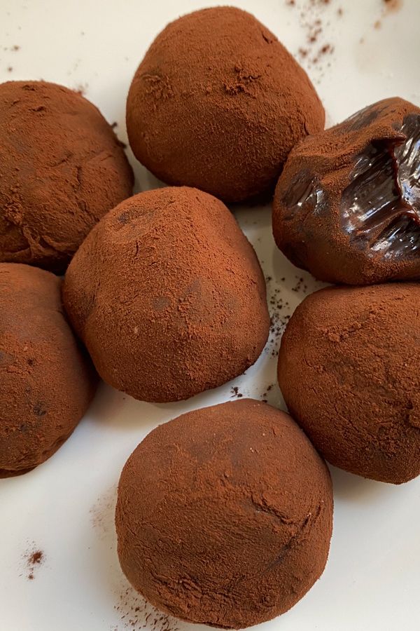 four chocolate donuts sitting on top of each other