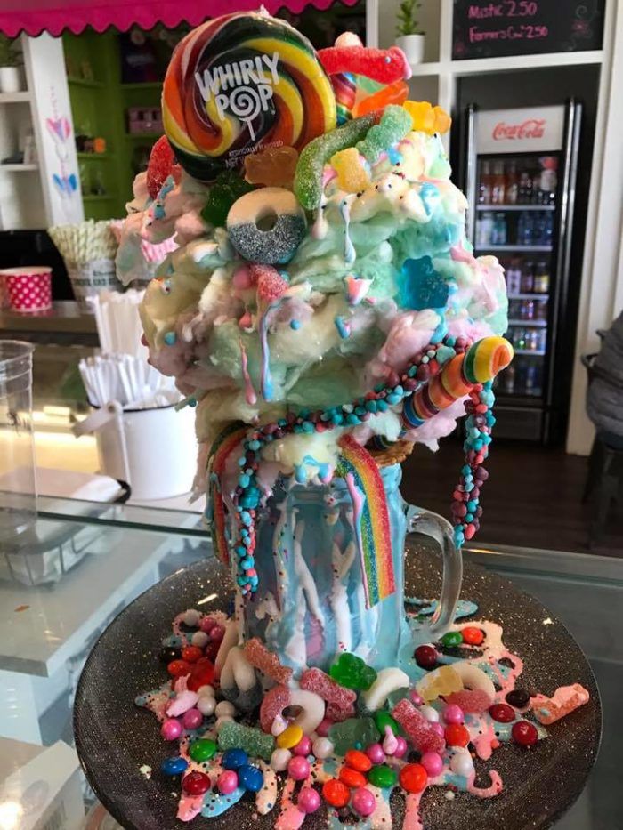 an ice cream sundae decorated with candy and candies