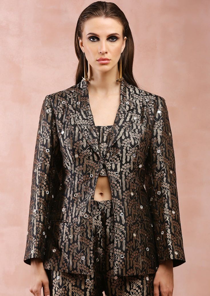 Black brocade embroidered blazer with bustier and pant. Disclaimer: Since we are a made-to-measure brand and our dyeing process and embroidery are handcrafted, there may be slight variations in the color and embroidery of the actual product. The print placement may also vary from what is represented in the images shown on the product page. Long Sleeve Bandhgala With Floral Embroidery For Parties, Festive Bandhgala With Floral Embroidery For Party, Party Long Sleeve Bandhgala With Floral Embroidery, Festive Party Bandhgala With Floral Embroidery, Fitted Brocade Sets With Floral Embroidery, Festive Party Sets With Set-in Sleeves, Fitted Brocade Sets For Evening, Fitted Brocade Evening Sets, Shawl Collar Jacket