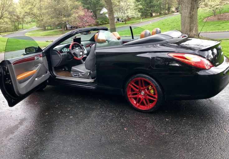 a black sports car with its doors open