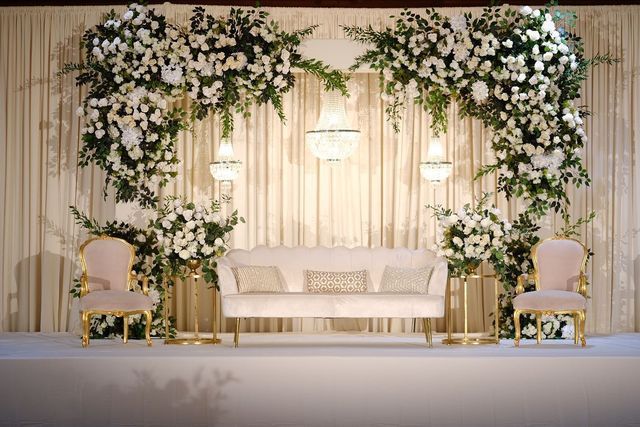 an elegant wedding setup with white flowers and greenery