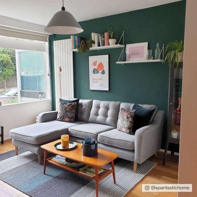 a living room filled with furniture and green walls