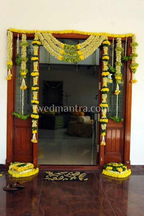 an entrance decorated with flowers and garlands