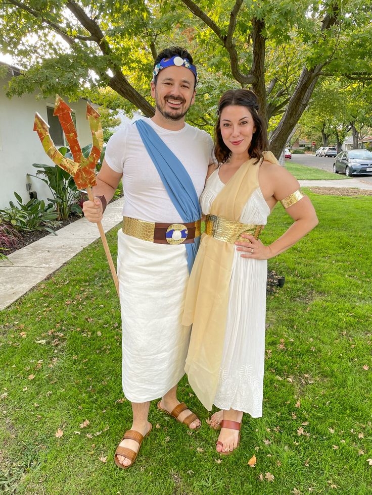 a man and woman dressed up in ancient greek garb posing for a photo together