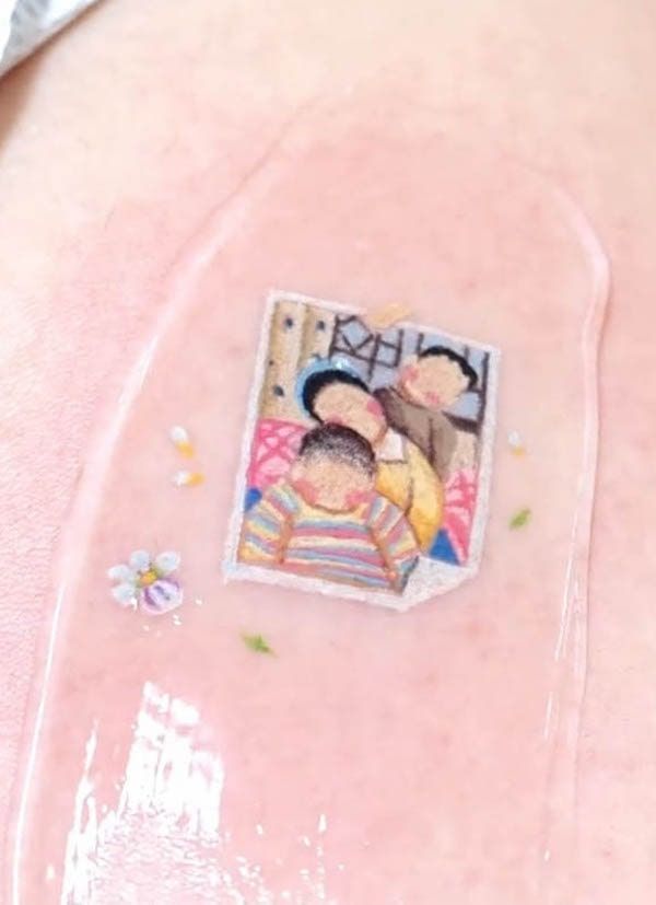 a pregnant woman's belly with an image of two children on it