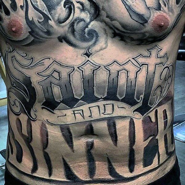 a man's chest with tattoos and lettering on it