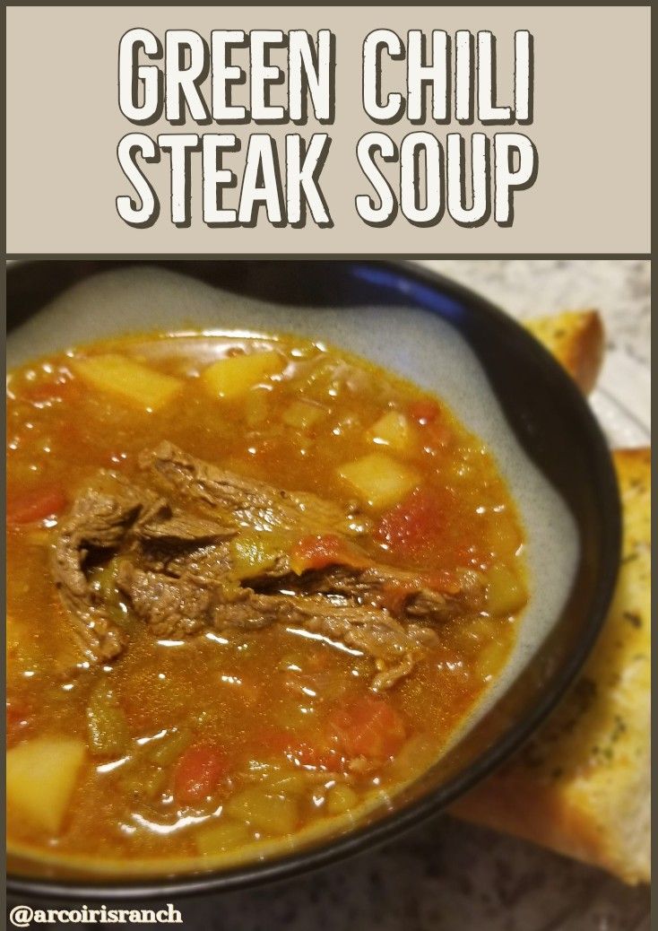 green chili steak soup in a bowl with bread on the side and text overlay