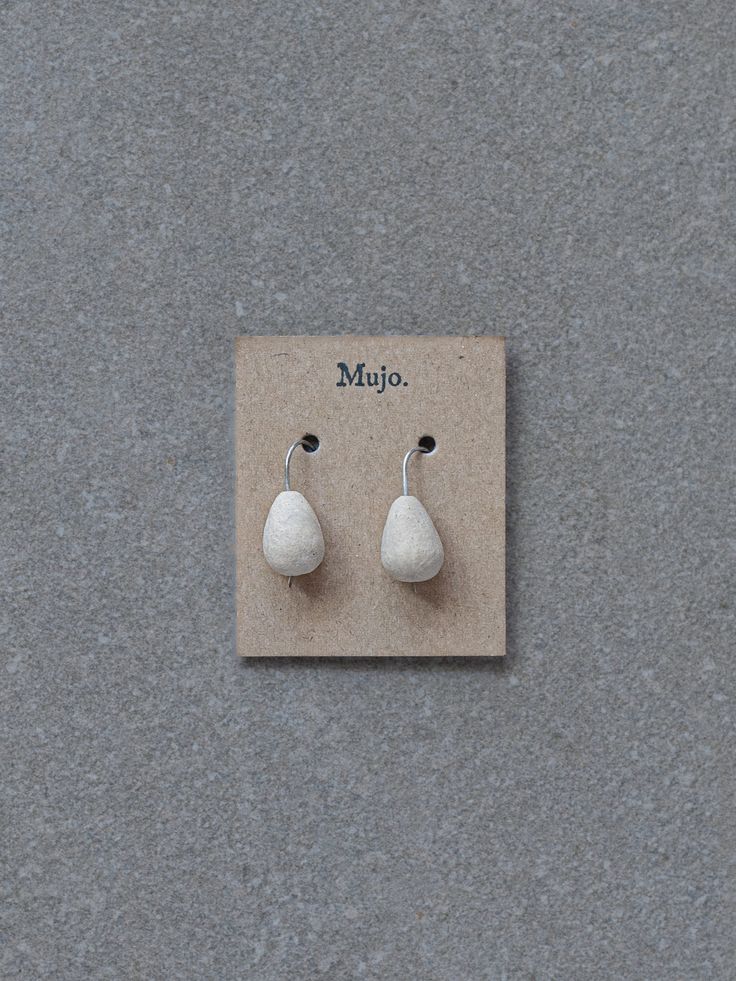 These earrings are lightweight and very versatile, perfect to wear casually or when you're wanting to feel a little more special. Each pair is individually handcrafted and hand finished, with a focus upon slow traditional processes - making hand-built stoneware ceramics and then hand forming silver wires through bending and hammering stages. Details: Colour: Natural unglazed stoneware clay Handcrafted from 100% stirling silver wires, and hand formed and fired drop shaped stoneware pottery beads. Handmade Teardrop Wrap Earrings In Minimalist Style, Handmade Minimalist Teardrop Wrap Earrings, Minimalist Jewelry In Natural Tones As A Gift, Artisan Teardrop Single Earring, Artisan Single Teardrop Earring, White Artisan Earrings For Pierced Ears, Handmade Minimalist Teardrop Earrings, Handmade Minimalist Dangle Wrap Earrings, Handmade Drop Wrap Earrings For Everyday