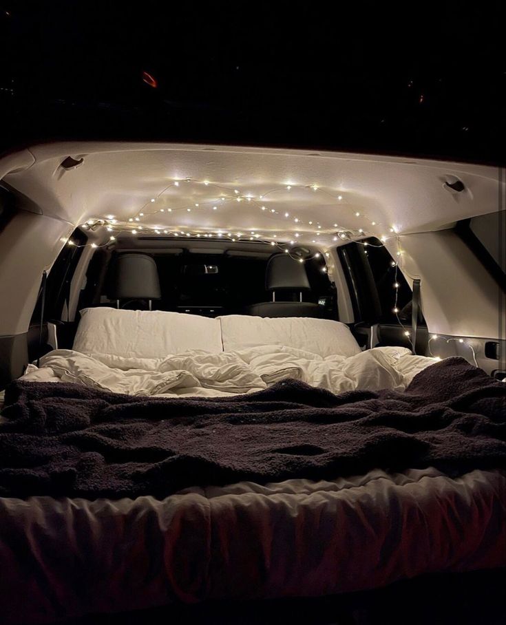 an airplane bed with lights in the back