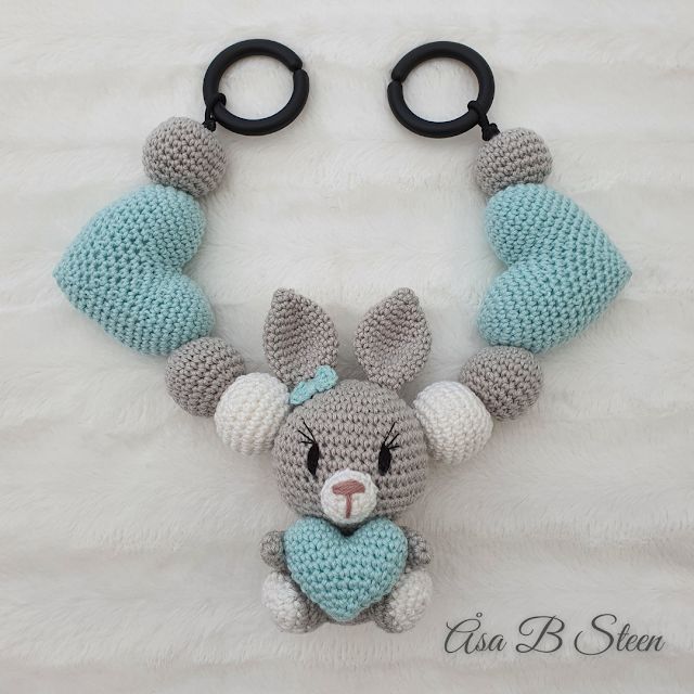 a crocheted stuffed animal hanging from a pair of scissors