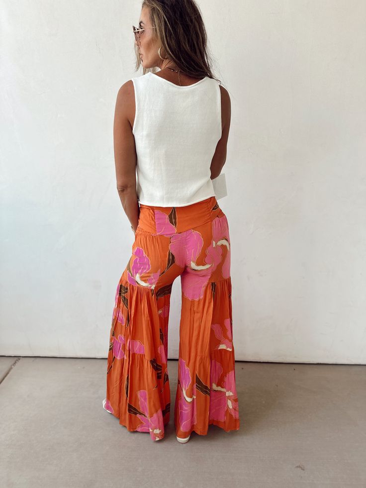 Tiered wide leg flare pants Ruffle Hem button Tie Waist with smocked waistbands on sides Run smalls. Size small 0-2, Medium size 4, Large 6-8 Wide Leg Flare Pants, Sunset Glow, Activewear Sets, Holiday Dresses, Hat Hairstyles, Flare Pants, Bra Tops, Ruffle Hem, Bottoms Pants