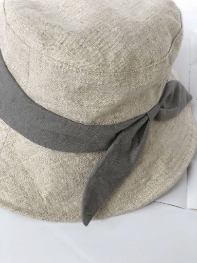 This stylish beige linen hat features a wide brim for excellent sun protection. Made from breathable, high-quality linen, it ensures comfort in warm weather. Available in large sizes up to XL (59-63 cm), it provides a secure fit for larger head sizes. Perfect for gardening, beach trips, and casual outings, this durable Linen Bucket Hat combines functionality with fashionable design.SpecificationsMaterial: 100% cottonSize: S:53-55cmM:56-58cmL:59-63cmBrim: 6.5-10cm Linen Hat, Navy Ribbon, Beach Trips, Outdoor Style, Wide Brimmed, Beach Trip, Warm Weather, Sun Protection, Large Size