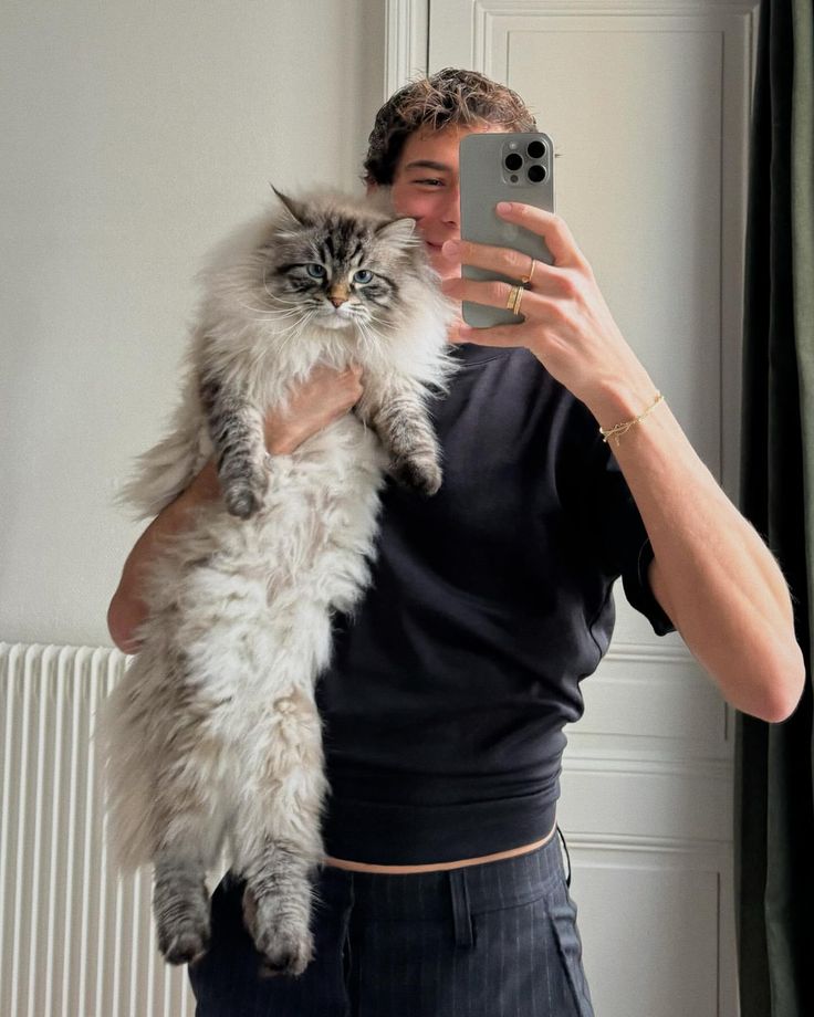 a woman taking a selfie with her cat