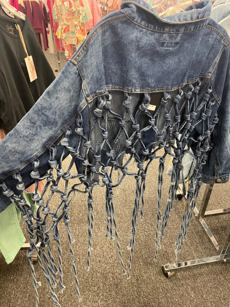 an old pair of jeans with chains attached to them are on display in a store