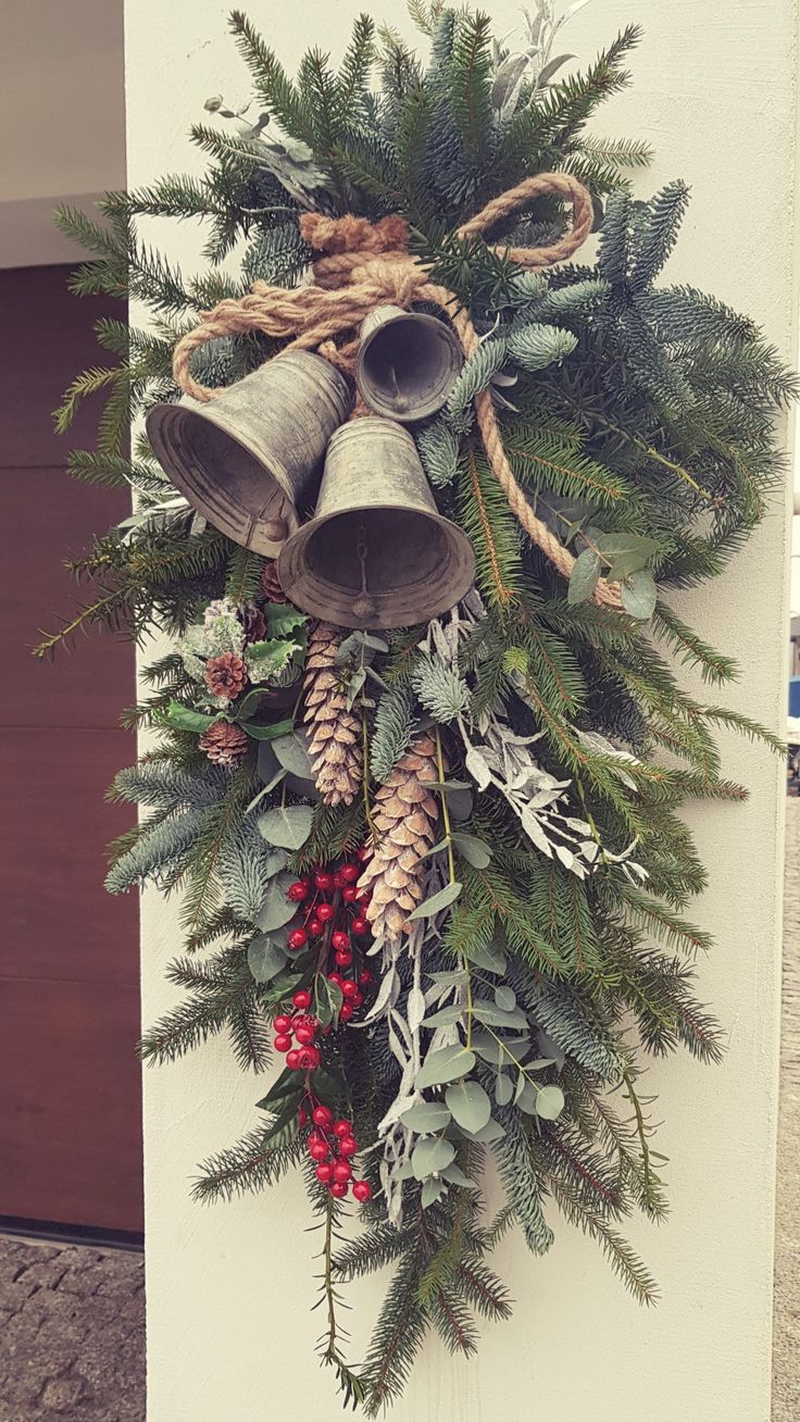 a christmas wreath with bells and pine cones