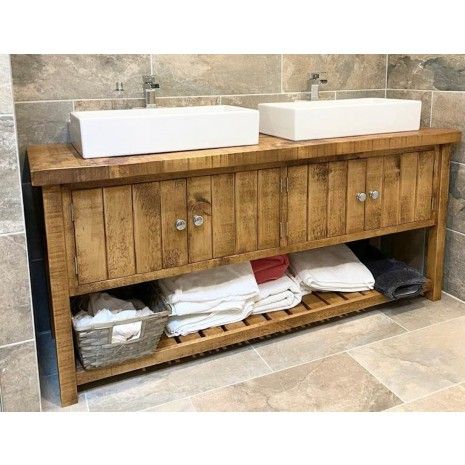 two white sinks sitting on top of a wooden cabinet