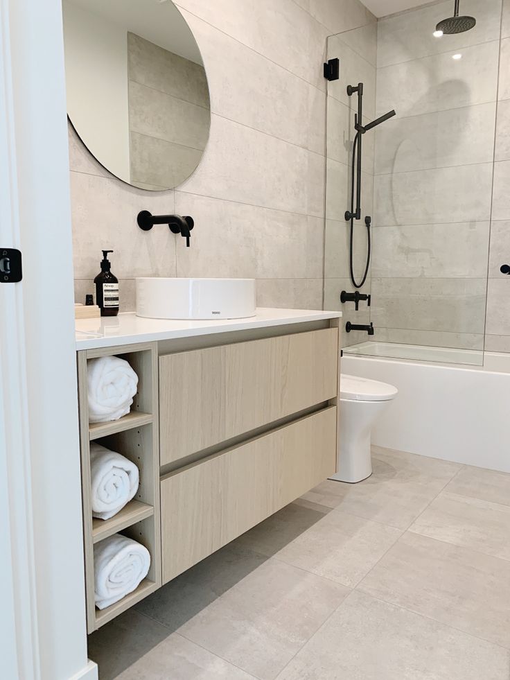 a bathroom with a sink, toilet and bathtub next to a walk in shower