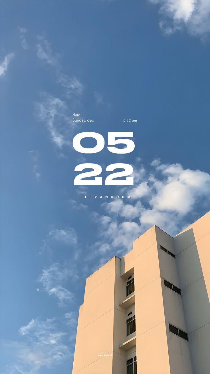 a tall building sitting under a blue sky with the number 052 on it's side