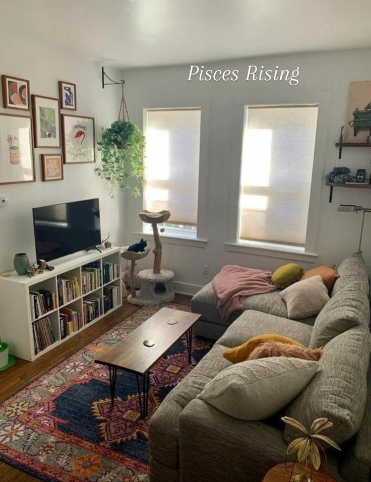 a living room filled with furniture and a flat screen tv on top of a wooden table