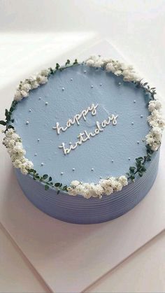 a blue birthday cake with the words happy birthday written in white frosting on it