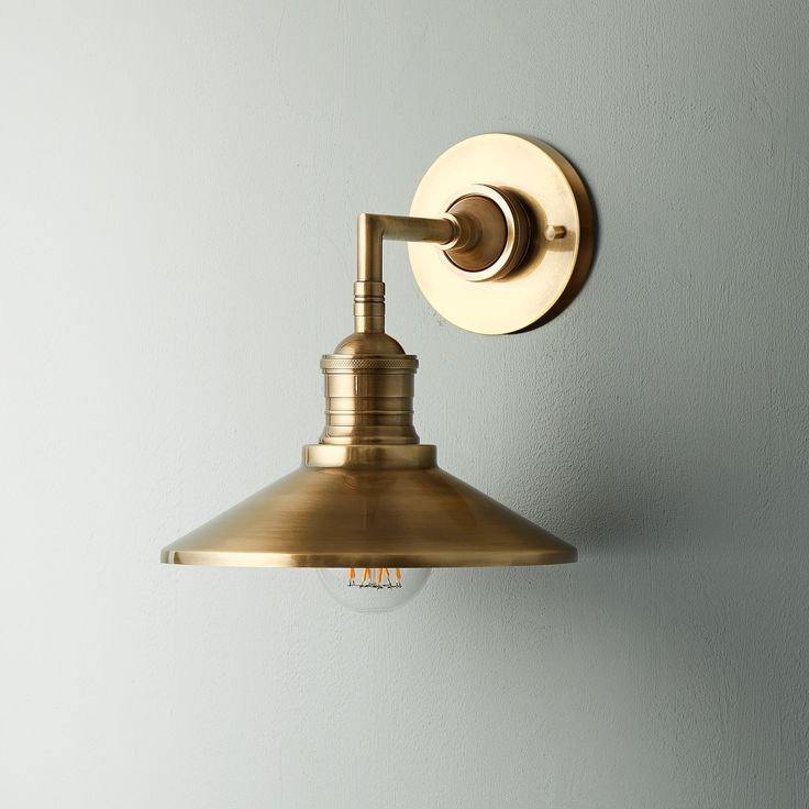 a light that is on the wall next to a white wall with a gray background