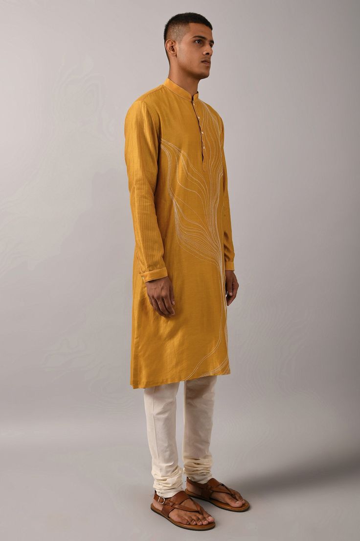 Mustard yellow straight kurta with placement thread work in abstract pattern. Comes with ivory cotton churidar.
Components:2
Embroidered
Neckline:Mandarin Collar
Sleeve Length:Full
Fabric:Chanderi, Cotton
Color:Yellow
Buttoned placket
Stitch lines
Side slits
Cuff sleeves
 - Aza Fashions Cotton Churidar, Cotton Kurta Set, Kurta Set Men, Yellow Outfits, Off White Pants, White Pant, Kurta Set For Men, Men Kurta, Mens Kurta